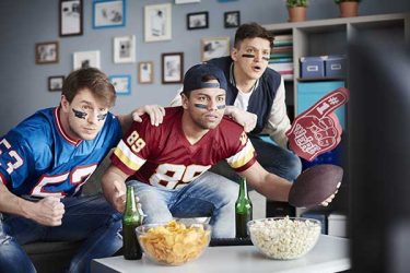 Three adult guys in anticipation of next score